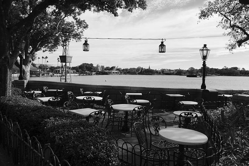Cable car wires strung above a riverside terrace, black and white