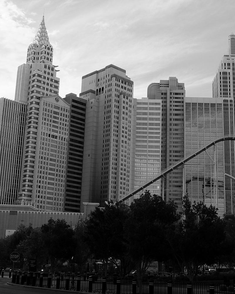 Monochrome cluster of high-rise towers seen from street level
