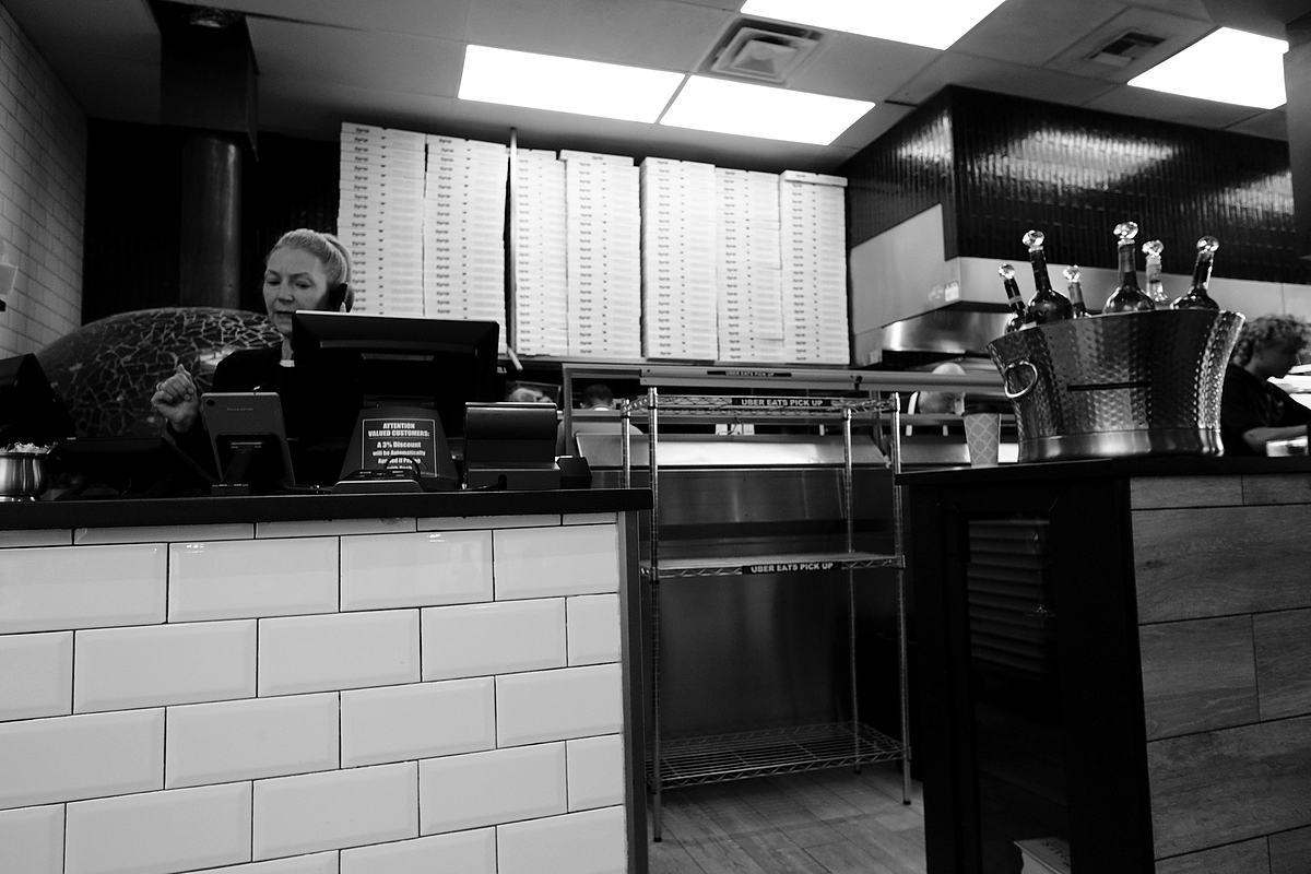 Counter service at a small restaurant, black and white