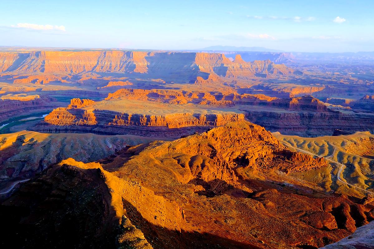 Canyon walls stepping back in layers of golden-hour light