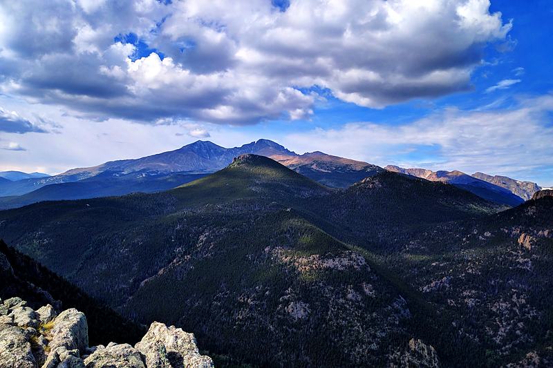 Mountain range beneath towering cumulus