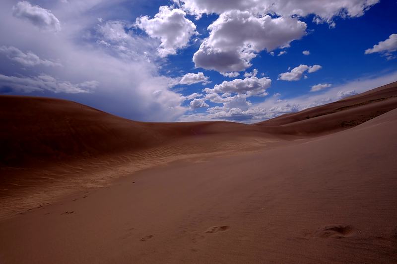Dune crest cutting a diagonal beneath broken cloud