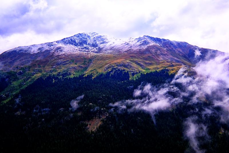 Snow peak emerging from cloud