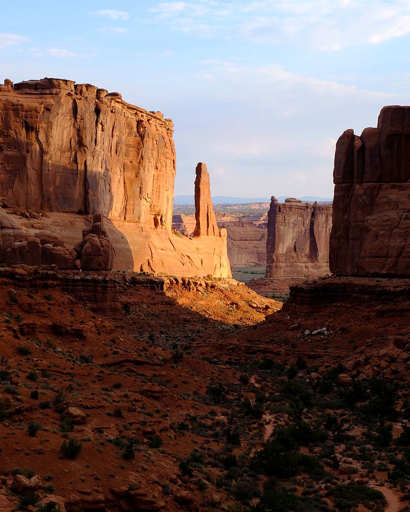 Red rock towers rising against a clear sky