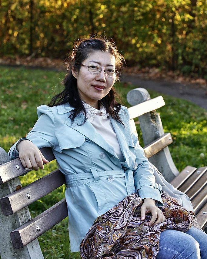 Woman resting on a park bench in autumn light
