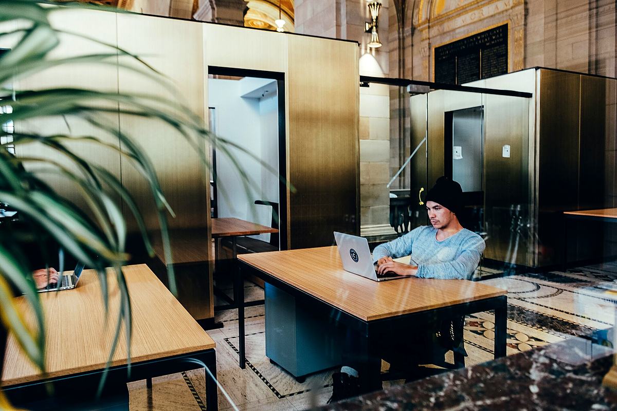 Reference frame: someone working at a desk behind a glass partition