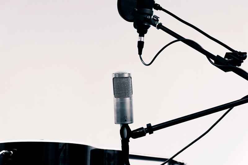 Reference frame: a microphone on a boom against a dark backdrop