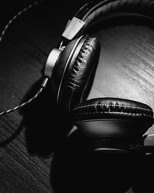 Reference frame: studio headphones photographed low key against black