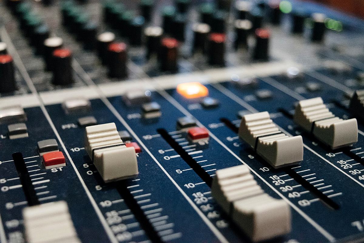 Reference frame: faders and rotary controls along a mixing console