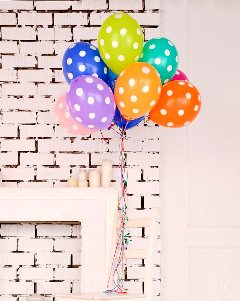 Reference frame: balloons against a white brick wall