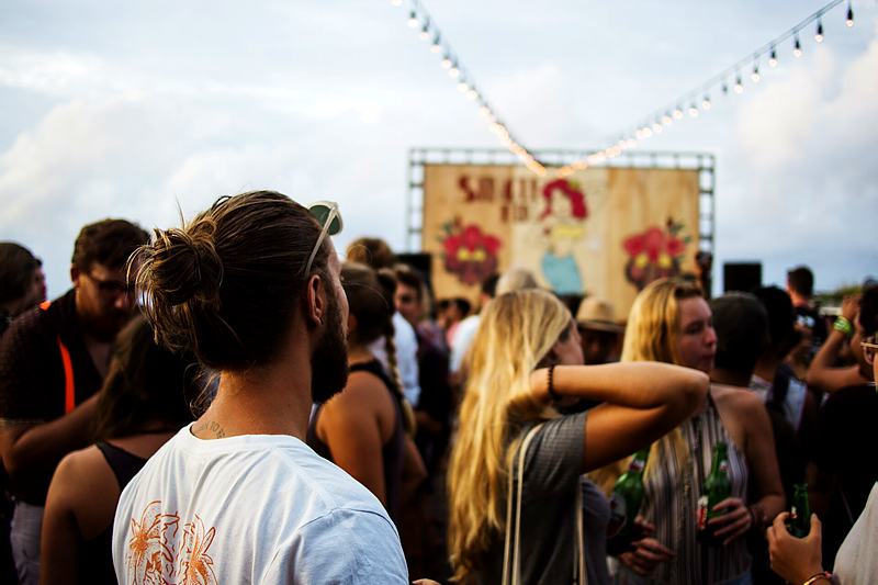 Reference frame: festival crowd under strings of lights at dusk