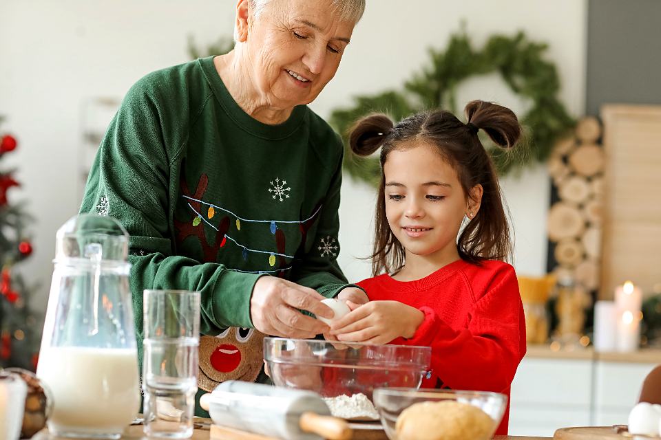 Reference frame: a grandmother and her granddaughter baking together