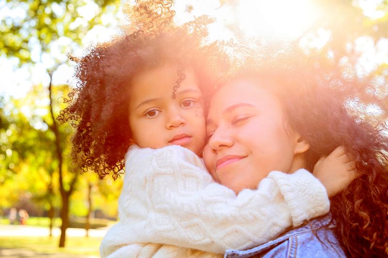 Reference frame: a mother and daughter cheek to cheek with their eyes closed