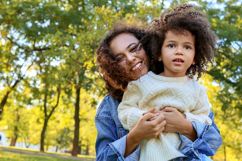 Reference frame: a mother and daughter photographed close, outdoors