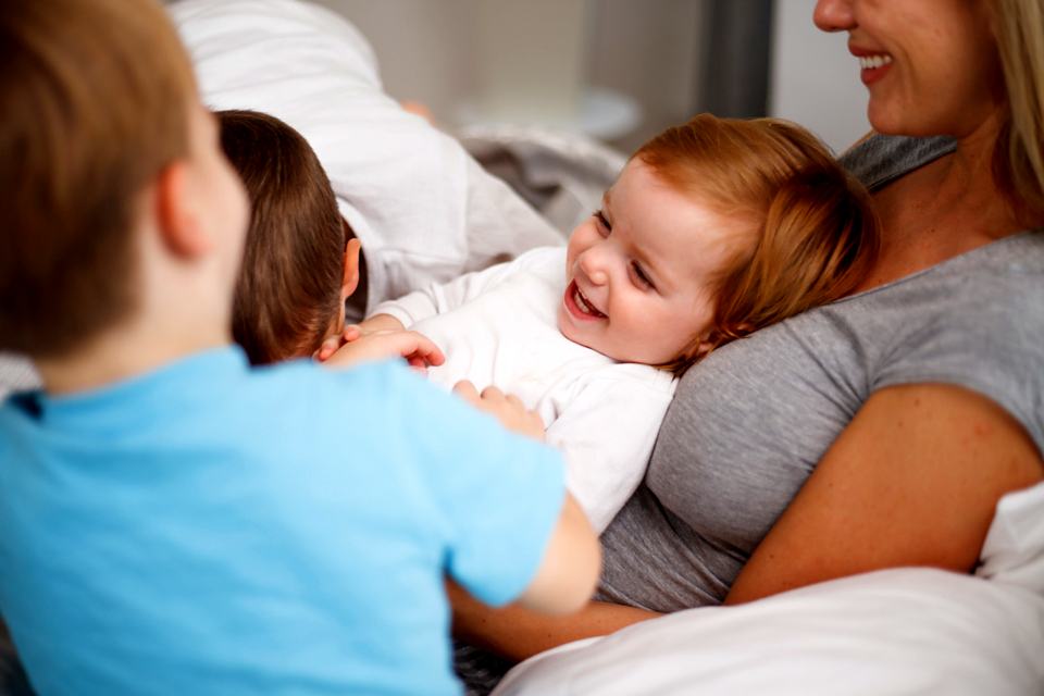 Reference frame: a family together in bed meeting the new baby