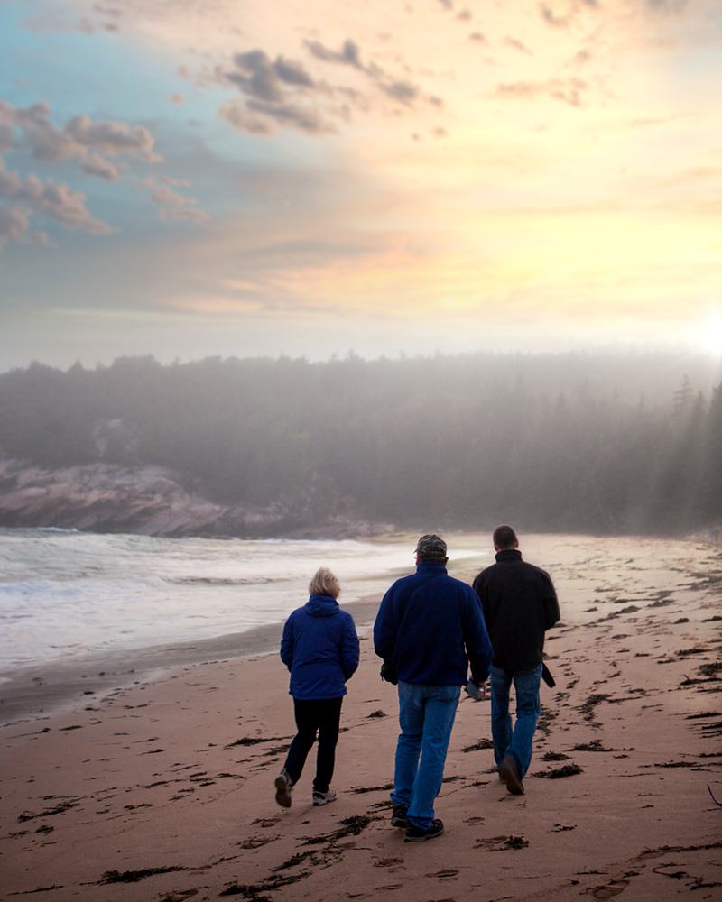 Reference frame: a family walking a misted shoreline at sunset