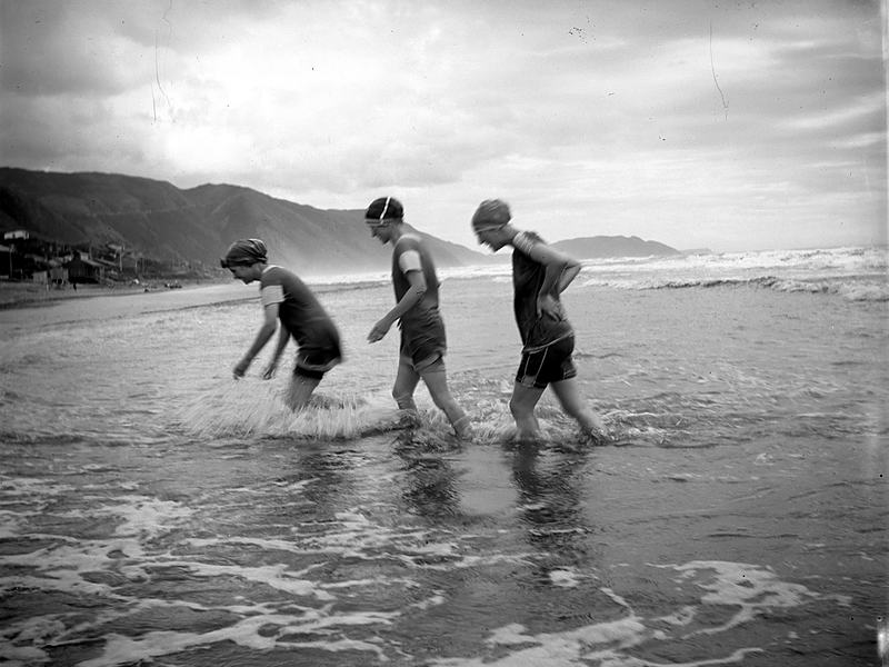 Reference frame: children wading in the surf, in monochrome