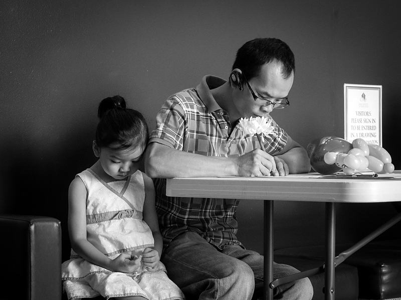 Reference frame: a father and daughter at a table together, in monochrome