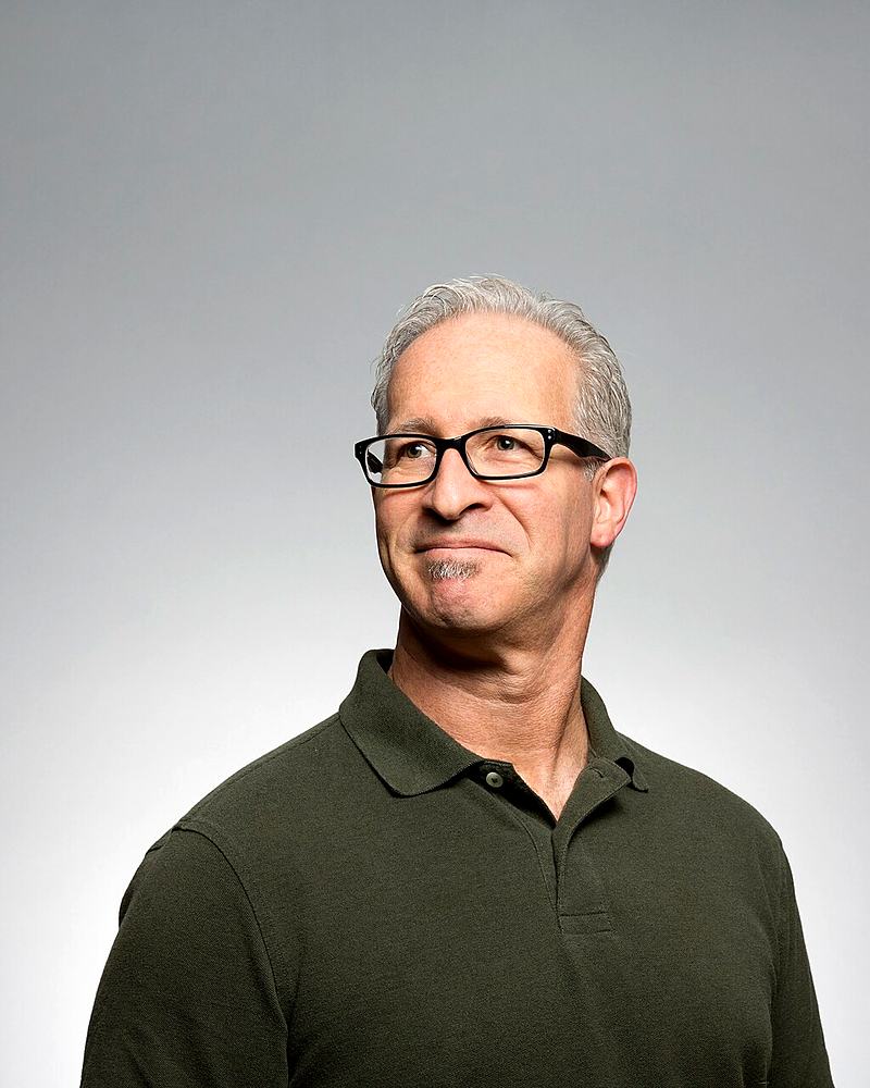 Reference frame: corporate headshot against a plain grey backdrop