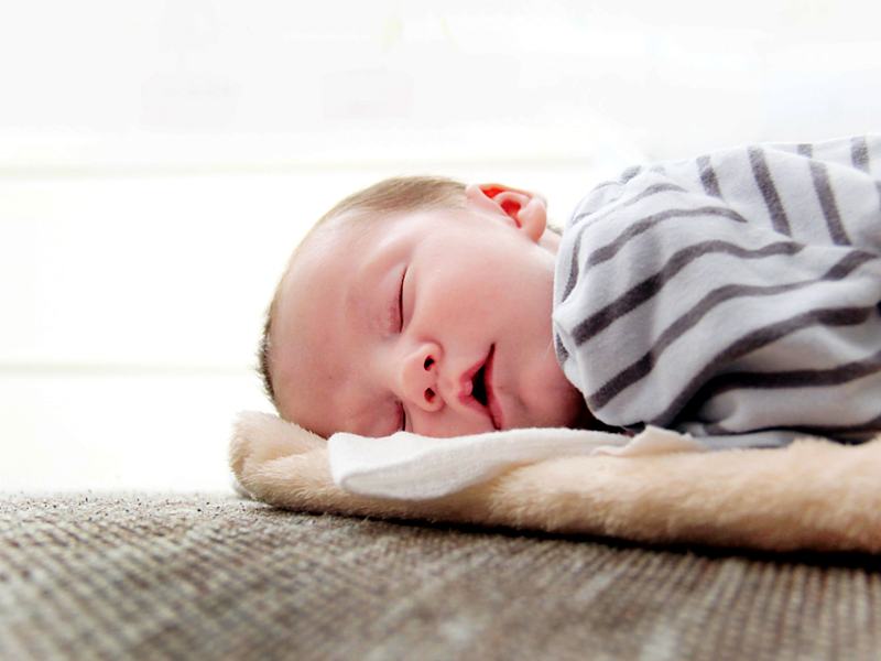 Reference frame: a newborn sleeping in soft daylight