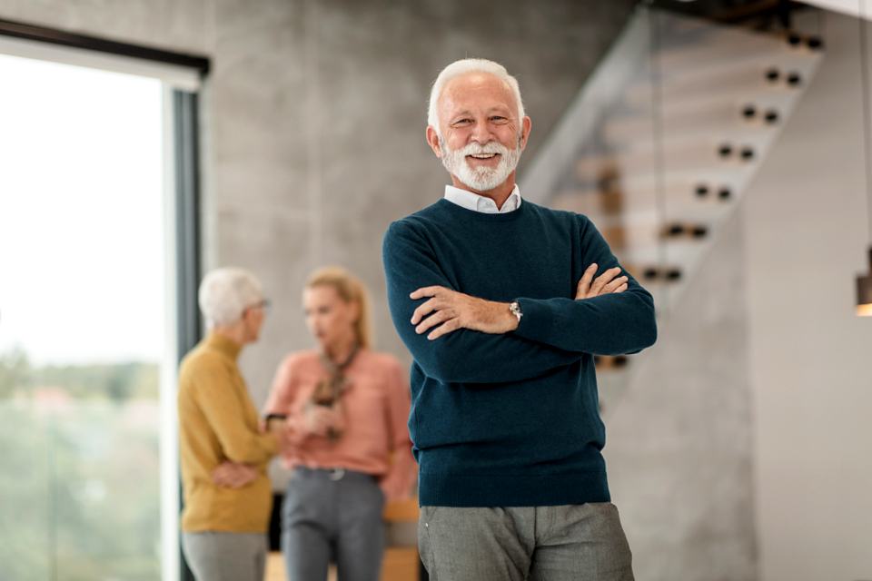 Reference frame: a senior professional photographed in an office atrium