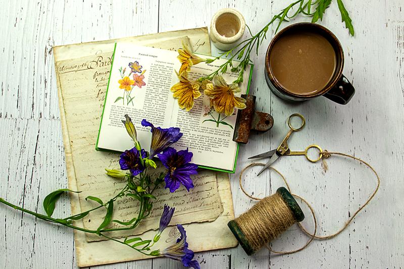 Reference frame: a flat lay of coffee, flowers and stationery