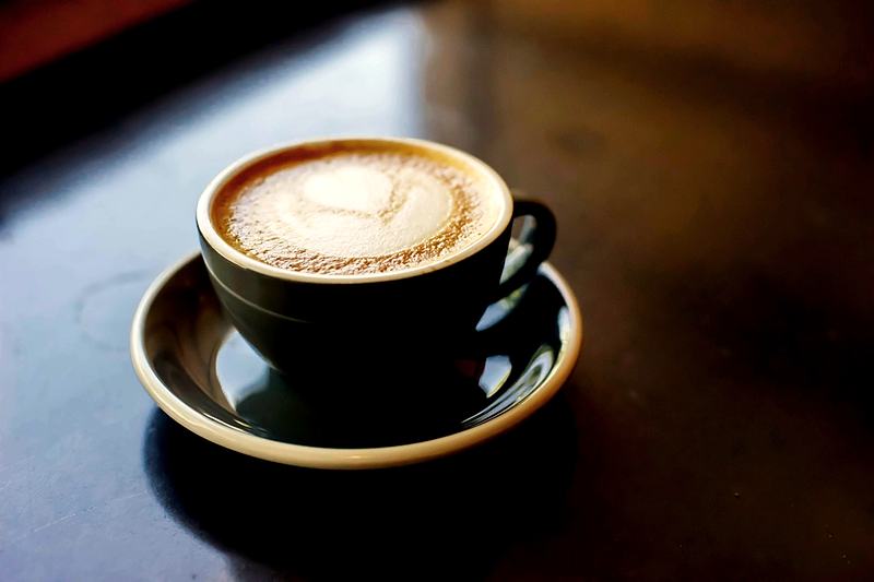 Reference frame: a latte with poured art, photographed overhead