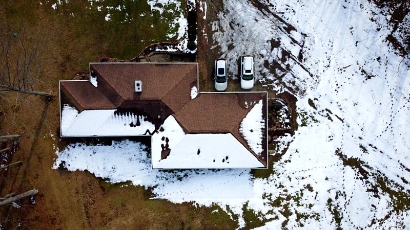 Reference frame: a drone view of a house in snow