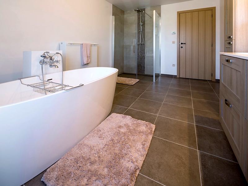 Reference frame: a freestanding tub standing on stone tile