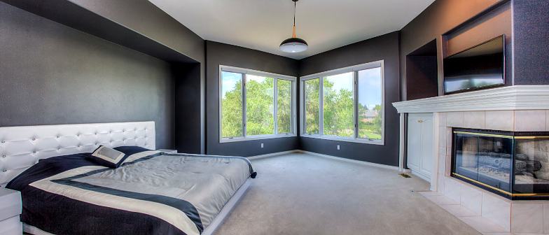 Reference frame: a bedroom with corner windows and a fireplace