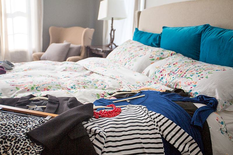 Reference frame: a made bed with teal cushions in morning light