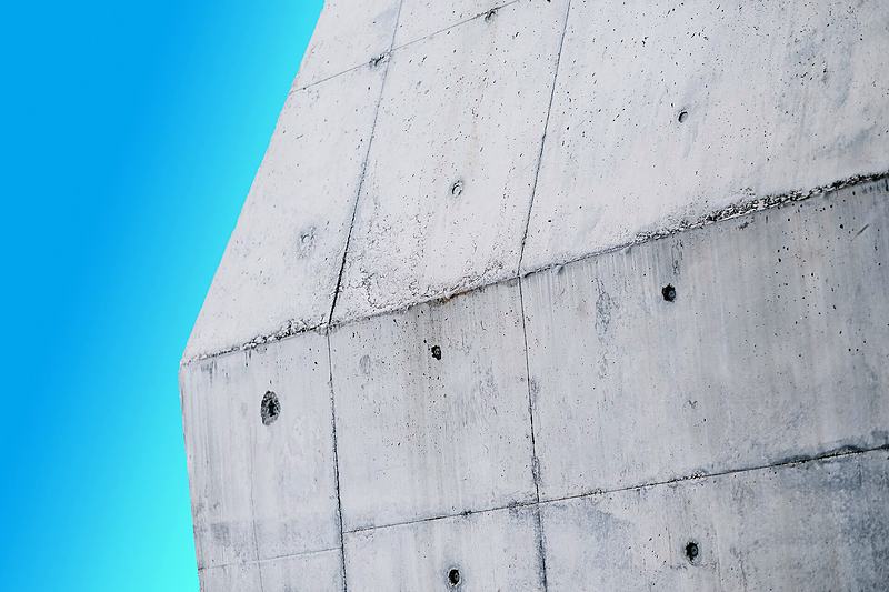 Reference frame: board-marked concrete meeting sky on a hard diagonal