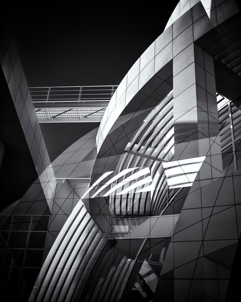 Reference frame: black and white abstract of a folding glass facade