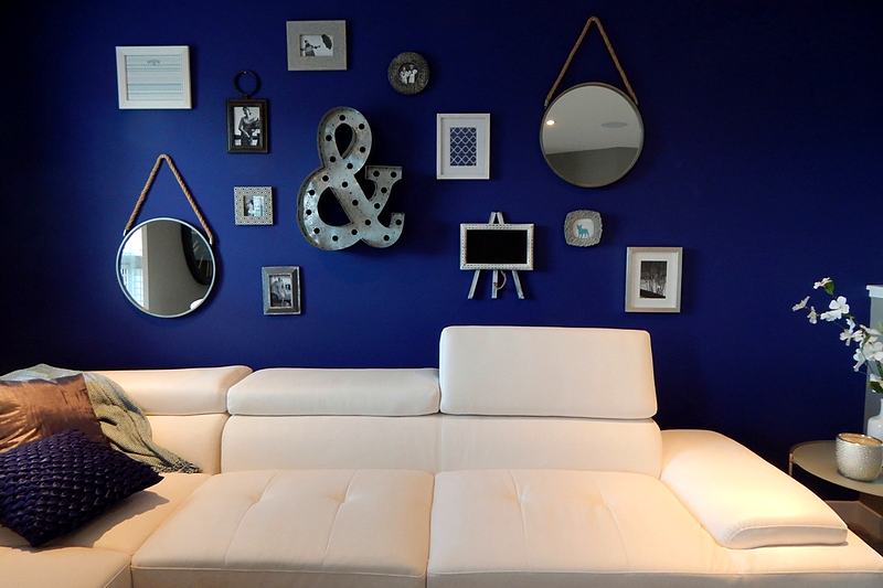 Reference frame: a living room with a deep navy gallery wall