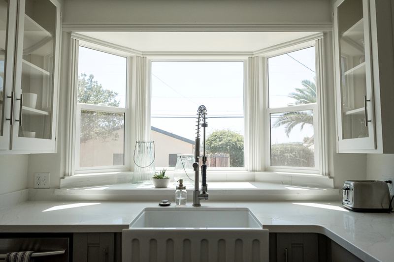 Reference frame: a farmhouse sink set under a bay window
