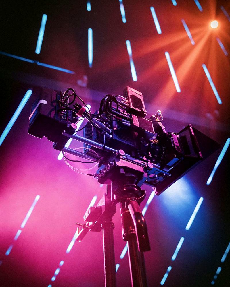 Reference frame: a cinema camera rig under coloured light