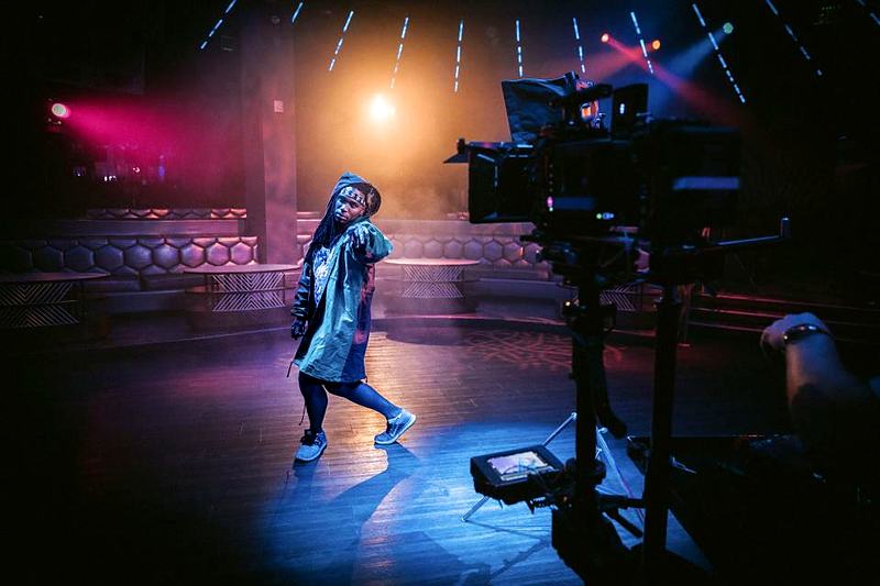 Reference frame: filming a performer on a lit stage