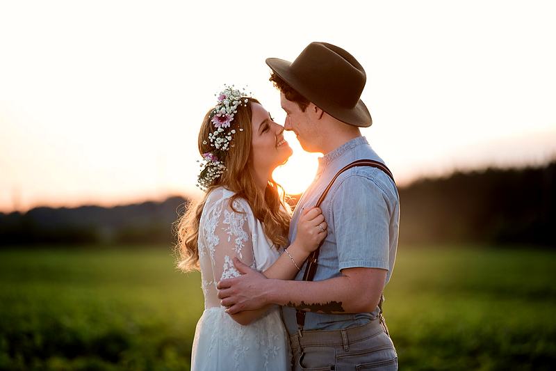 Reference frame: couple forehead to forehead in a field at sunset